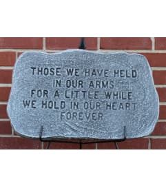 Those we have held in our arms Memorial Stone. An arrangement by North Liberty Flower Shop.