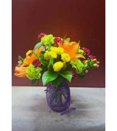 Florist Choice in Mesh Wrapped Vase. An arrangement by KW Flowers.