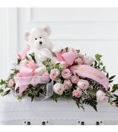 Touch of Sympathy casket. An arrangement by Conny's Flower Shop.