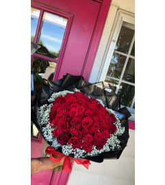Love Amor Wrapped bouquet. An arrangement by Floreria Aurora.
