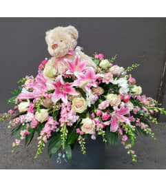 Casket Spray with Bear. An arrangement by Royal Louis Florist.
