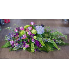 Blue and Purple Casket Spray. An arrangement by Northwest Florist.