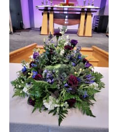Surrounded in Violet Urn Wreath. An arrangement by The Farm and Floral Market.
