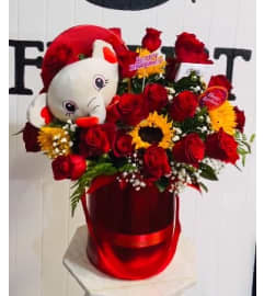 Roses and Plush. An arrangement by Geni's Florist and Gifts.