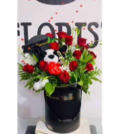 Dozen Roses Plush. An arrangement by Geni's Florist and Gifts.