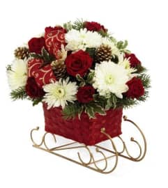 christmas sled. An arrangement by Conny's Flower Shop.