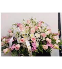 Casket Spray Pinks. An arrangement by Geni's Florist and Gifts.