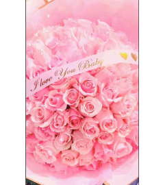 Buchon Roses Wrapped. An arrangement by Geni's Florist and Gifts.