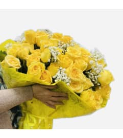 100 Yellow Roses Wrapped. An arrangement by Flower World and Gifts.