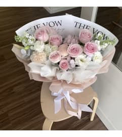 Peachy Petal Fusion. An arrangement by Win's Flowers.