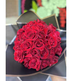 Ramo Buchon Red Roses. An arrangement by Blooming Bay Florist.