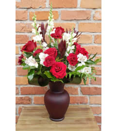 By Design Love In Bloom. An arrangement by Flowers By Design.