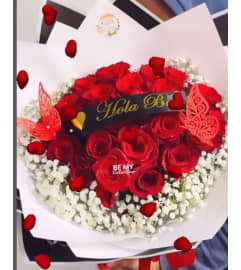 Red Roses wrap Bouquet. An arrangement by Geni's Florist and Gifts.