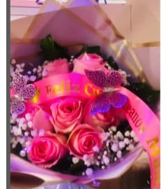 Pink Roses wrap Bouquet. An arrangement by Geni's Florist and Gifts.