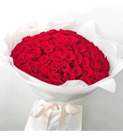 One Hundred Long Stem Premium Red Roses Wrapped. An arrangement by Alliston Flowers.
