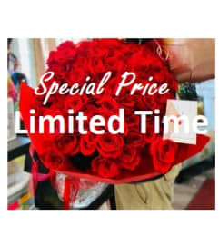 100 Red Roses Wrapped. An arrangement by Geni's Florist and Gifts.