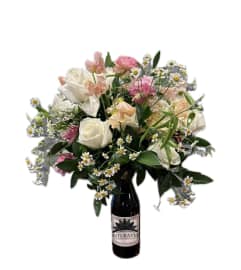 Mix arrangement in top of the wine bottle.. An arrangement by Inti-Raymi Flowers.