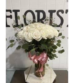 White Roses Boutique. An arrangement by Geni's Florist and Gifts.