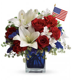 America The Beautiful (Teleflora). An arrangement by North Liberty Flower Shop.