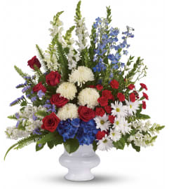 With Distinction Bouquet (Teleflora). An arrangement by North Liberty Flower Shop.