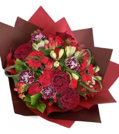 Romantic Red (Hand-tied bouquet). An arrangement by Flowers and Beyond.