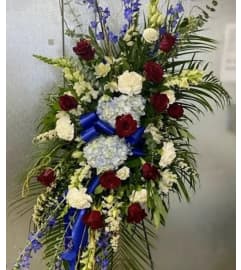 Red, White, and Blue Tribute Standing Spray. An arrangement by Bourbon Babes Bouquet and Boutique.
