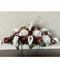 Bronze Tombstone Saddle. An arrangement by Loyalist Flowers.