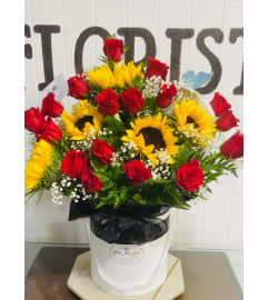 Sunshine and Scarlet Romance. An arrangement by Geni's Florist and Gifts.
