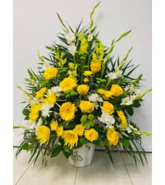 Basket of gold. An arrangement by Jennifer's Flowers and Gifts.