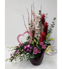 White and Purple Orchids. An arrangement by Jennifer's Flowers and Gifts.