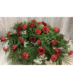 Red Carnation and Red Rose Casket Spray. An arrangement by Roma Flowers and Gifts.