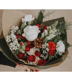 Crimson and Snow Wrapped Bouquet. An arrangement by Canmore Flowers by Alpine Blooms.