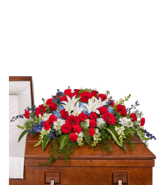 Stars and Stripes Forever Casket Spray. An arrangement by The Flower Shop of Lake Charles.