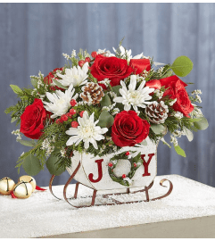 Dashing Through the Snow Joy Sleigh. An arrangement by North Liberty Flower Shop.