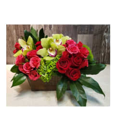 Orchid and Rose Serenade by Twigs and Blooms. An arrangement by Twigs and Blooms Florist.