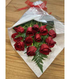12,18 or 24 Red Roses and Greens in a Hand Tied Bouquet - NO VASE. An arrangement by Deer Valley Florist and Flower Delivery.
