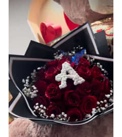 Letter bqt. An arrangement by Illusion Flower Shop.