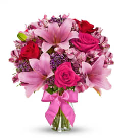Rose and Lily Celebration of Love. An arrangement by Conny's Flower Shop.