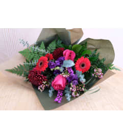 Radiant Romance Wrapped Bouquet. An arrangement by Canmore Flowers by Alpine Blooms.