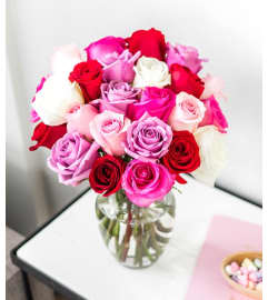 3 dozen stunning roses multi colours in a vase. An arrangement by Flowers By Gerry.