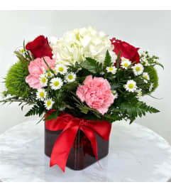 Blushing Harmony Arrangement. An arrangement by Rosebud Studio Florist.