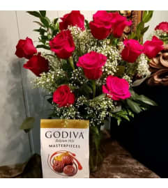 DOZEN ROASES WITH LARGE BAG OF GODIVA. An arrangement by Flowers by Priscilla.