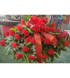 Red Silk Carnation Casket Spray. An arrangement by Ebony's Flowers and Gifts.