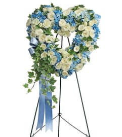 Heavenly Blue Heart Tribute. An arrangement by Geni's Florist and Gifts.