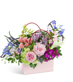 Petal Prelude Tote. An arrangement by The Flower Shop of Lake Charles.
