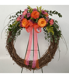 Grapevine Wreath with Simple an Elegant flowers. An arrangement by Flowers by Priscilla.