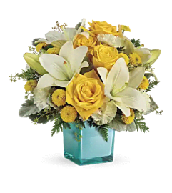 Teleflora's Golden Laughter. An arrangement by Mae's Flowers and Gifts.