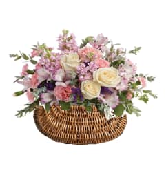 Pastel Dreams Basket. An arrangement by Geni's Florist and Gifts.
