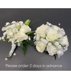 White/Silver Mini Roses Corsage Duo. An arrangement by Violeta's Flower Shop.