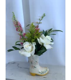 Garden Steps - Ceramic Cowboy Boot Arrangement. An arrangement by Anderson Flowers.